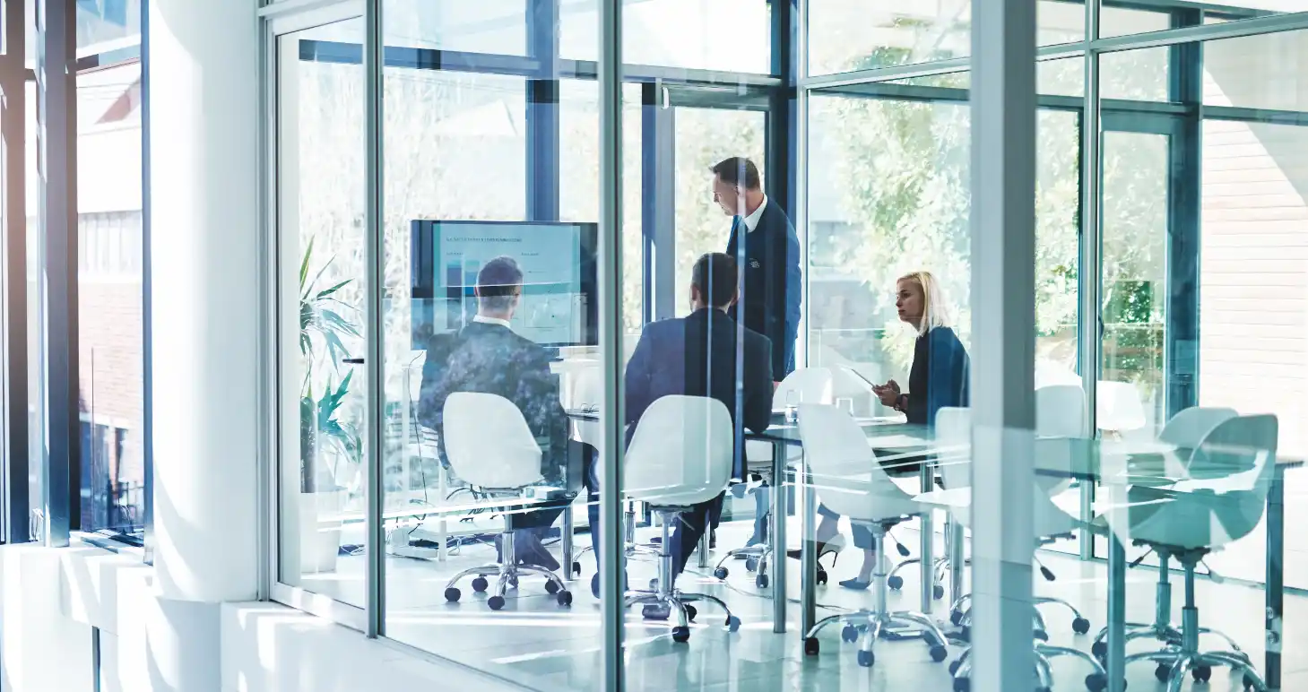 business professionals in meeting in modern lit office
